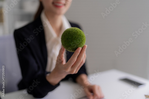 Asian Business Woman Holding Green Ball at Office Environmental Sustainability Promoting Corporate Social Responsibility for Better World Climate Action Programs