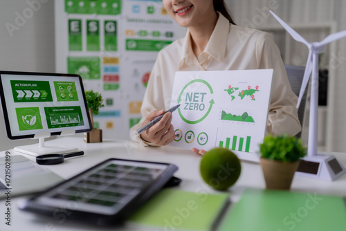 Asian Business Woman Presenting Net Zero ESG Strategy for Sustainability Development and Renewable Energy at Modern Workplace Promoting Corporate Social Responsibility