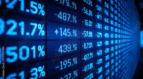 A dynamic, close-up, and highly detailed perspective shot of a digital stock market ticker or financial data screen. The image is dominated by a deep, intense blue color palette, giving a futuristic.