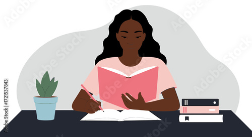 A young black woman with long, dark, wavy hair sits at a desk, wearing a pink tshirt, and is engrossed in reading a book while writing in a notebook, with a potted plant and a stack of books nearby