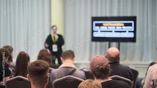 Wallpaper Mural A speaker presenting to an audience in a conference setting with a monitor visible. Torontodigital.ca