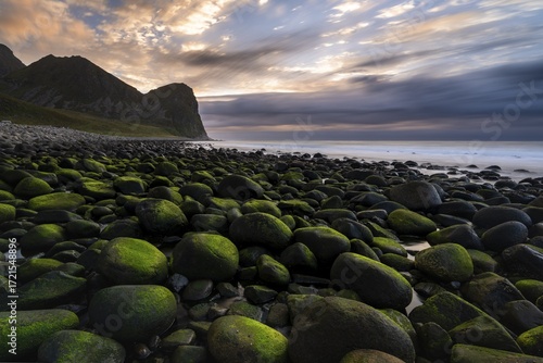 Moss-covered, round stones at Unstad Beach, Lofoten, Norway
