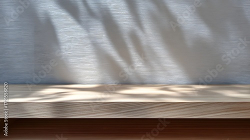 Empty wooden table top with a clean, minimalist design and natural texture, featuring soft shadows and highlights creating an abstract, geometric pattern