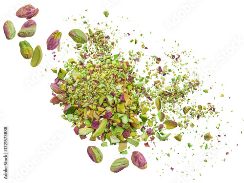 Pistachio crumbs  explosion. Levitating peeled pistachio pieces shattering isolated on white background. Falling pistachio nut chunks, shavings and  crumbs 