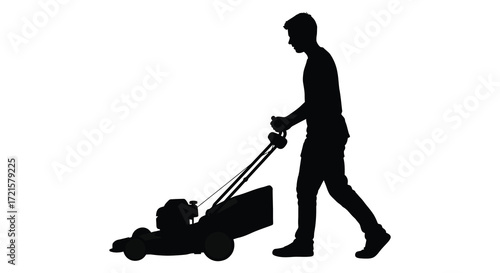 Silhouette of a man mowing a lawn with a push mower