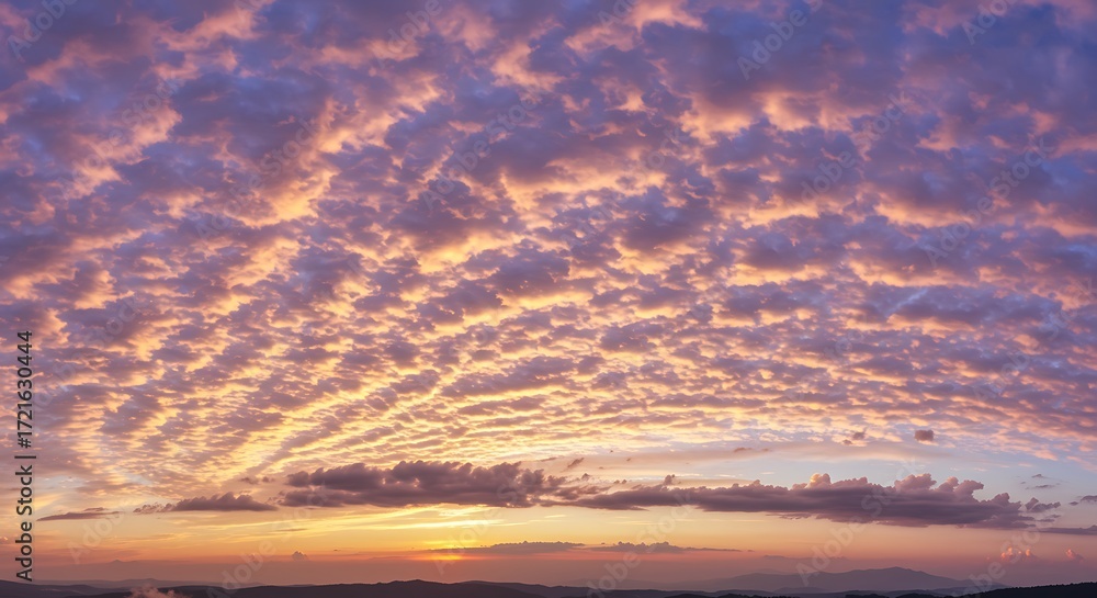 Obraz premium Stunning skyscape at dusk featuring dramatic purple and orange altocumulus clouds creating a breathtaking mackerel sky effect