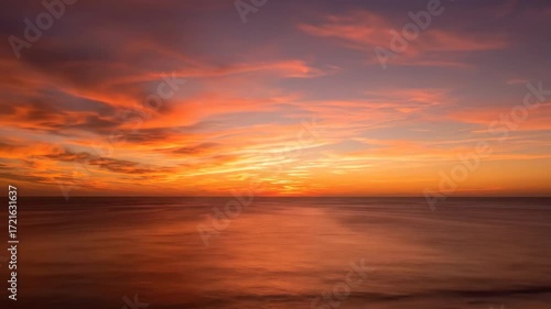 Wallpaper Mural Golden hour sunset colors paint the sky as fast-moving clouds sweep over a vast, tranquil ocean timelapse vast, holiday, colorful Torontodigital.ca