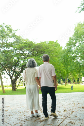 Happy Asian Senior Couple Relaxing Together in Park with Wheelchair