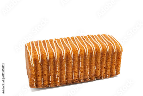 Loaf cake with golden crust and white icing lines, angled side view on a white background. A soft and sweet bakery classic. The image is isolated on a transparent PNG background.