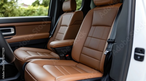 Close-up view of luxurious brown leather car seats in an elegant vehicle interior.