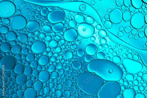 Close up of oil drops on water surface. Colorful abstract macro background of oil drops on water surface with air bubbles inside. Colorful background for gadget and computer wallpaper