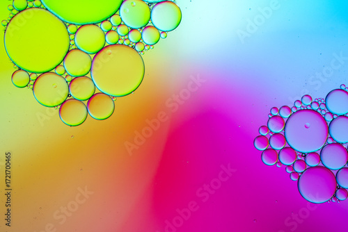 Close up of oil drops on water surface. Colorful abstract macro background of oil drops on water surface with air bubbles inside. Colorful background for gadget and computer wallpaper