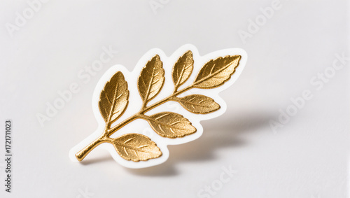 Golden leaf design on a clean white surface showcasing elegance