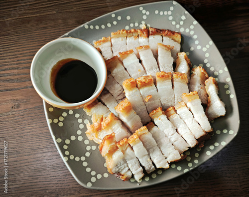 Crispy fried pork belly on a wooden table