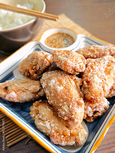 Japanese style fried chicken wings on a wooden table