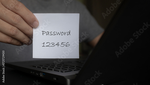 A person's hand holds a white notepad with the word password and the numbers 1234 written on it. Concept of office work, internet, wifi password. Including the security of the wifi network system.