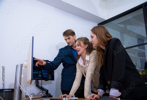Innovative team collaboration modern office setting, showcasing three professionals engaged discussion while analyzing data computer screen. Their expressions reflect enthusiasm and teamwork.