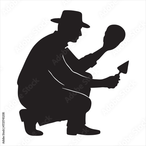 Silhouette of a baseball catcher in crouched position holding a glove and ball