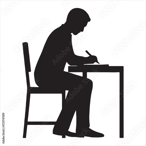 Silhouette of a person sitting at a desk writing with a pen on paper in a studio setting