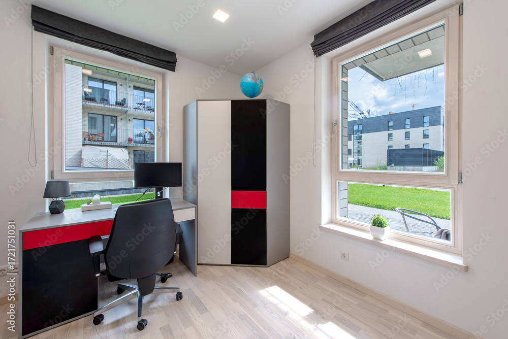 Obraz premium Modern Home Office Interior with Desk and Window Overlooking Relaxing Outdoors