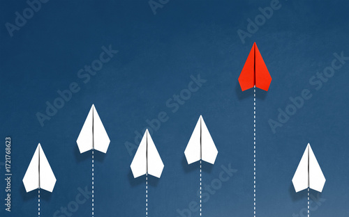 An image of a paper airplane soaring ahead, leading the pack and surpassing many others.