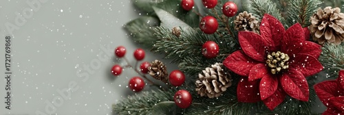 Holiday floral arrangement featuring red poinsettia and festive greenery in a snowy backdrop