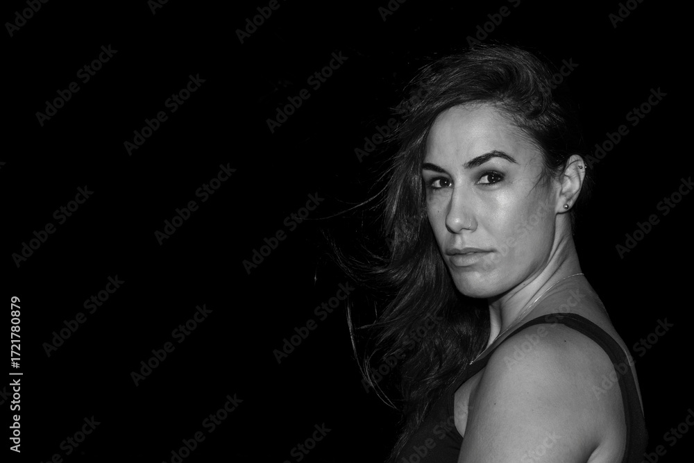Naklejka premium Woman with strong gaze and flying hair portrait