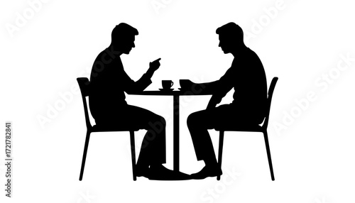 Two men discussing at a table with coffee in silhouette  