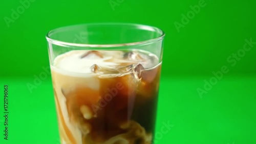 Wallpaper Mural Slow motion shot of iced coffee with cream swirling inside the glass, cinematic detail, ultra HD, green screen background, highly realistic, perfect for beverage ads Torontodigital.ca