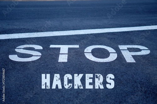 stop hackers. words written on the pavement, on a traffic sign