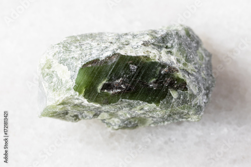 sample of rough green nephrite mineral on white