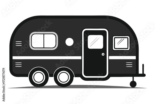 Vintage travel trailer parked outdoors during sunny day in quiet setting