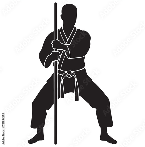 Silhouette of a martial artist holding a bo staff in a ready stance martial arts karate