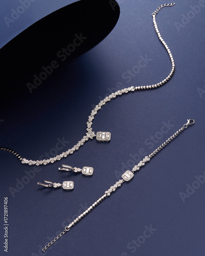 Elegant silver jewelry set with rectangular baguette pendants and intricate zigzag chain design