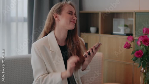 Caucasian woman looking at mobile phone device at home living room failure lose game frustrated female girl with smartphone scam message, disappointed stressed upset emotional despair,