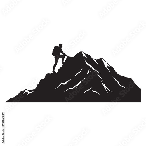 Silhouette of a hiker climbing a rocky mountain peak