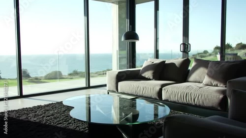 Modern living room with expansive ocean views showcases minimalist design and natural light.