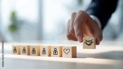 A wooden block symbolizing empathy and partnership among individuals, highlighting emotional intelligence, trust, and team collaboration in leadership.