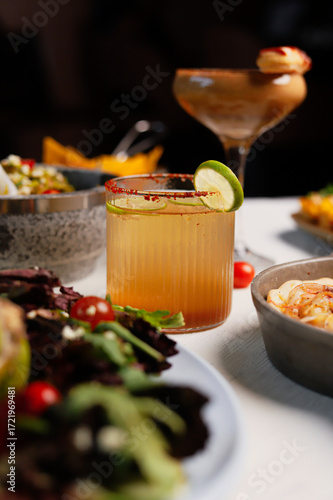 Spicy Citrus Cocktail with Lime Garnish and Salt Rim