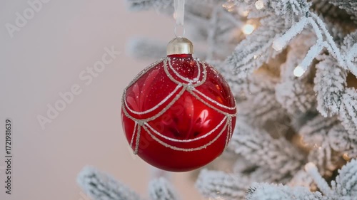 Red bauble Christmas tree holiday decor, frosted pine needles sparkling lights, winter festive background, seasonal atmosphere, New Year celebration ornament, cozy decoration detail, traditional Xmas 