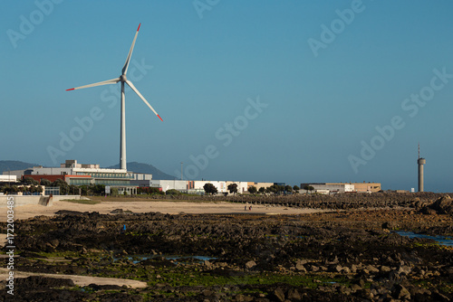 Wind turbine in Viana do Castelo near the beach at sunset, Portugal.