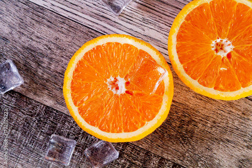 Orange and ice top view. Ice drink made from ice and orange. Summer freshness. Refreshing juice with ice.