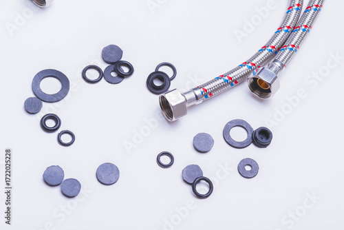 A water tap and a hose in a metal braid. Accessories for the repair of water supply..
