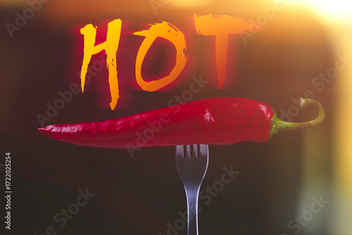 Hot chili peppers on fork. Extra spicy. Mexican food with pepper. Seasonings and spices. Hellish seasoning..