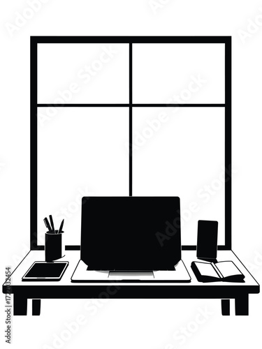 Silhouette of a modern desk with laptop and window view