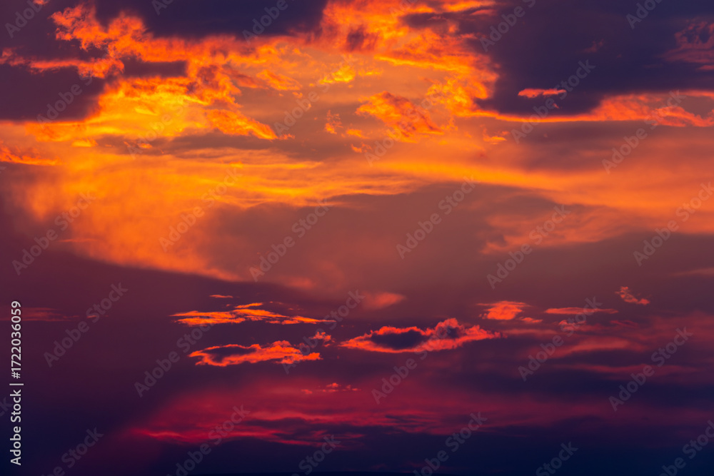 Fototapeta premium Deep orange sunset with backlit clouds
