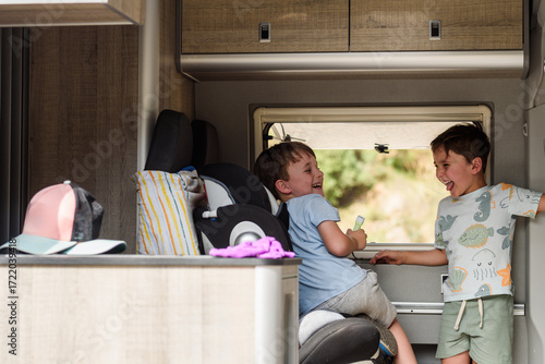 Happy brothers laughing during summer road trip