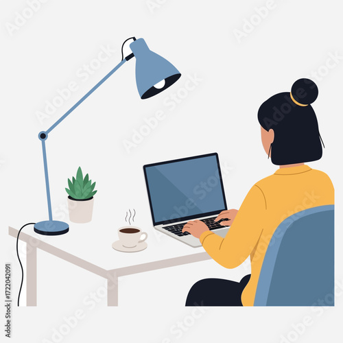 Woman Working on Laptop at Desk with Lamp, Coffee, and Plant in Modern Office Space