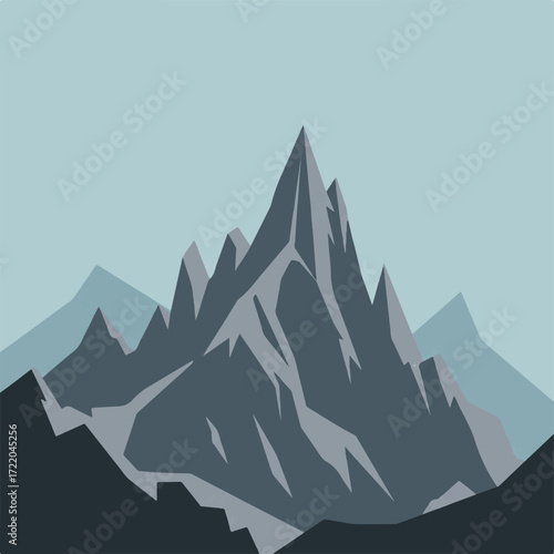 Jagged grey mountain peaks against a pale blue sky