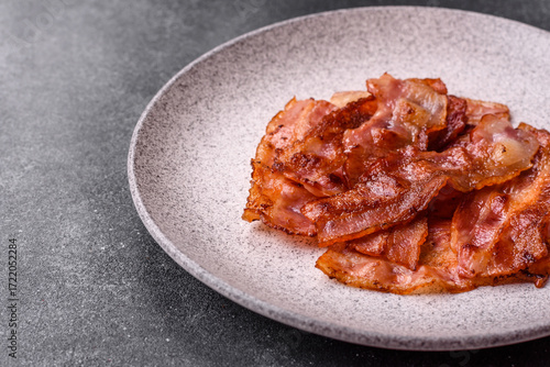 Fried pork bacon slices or strips as a breakfast ingredient. Fried bacon
